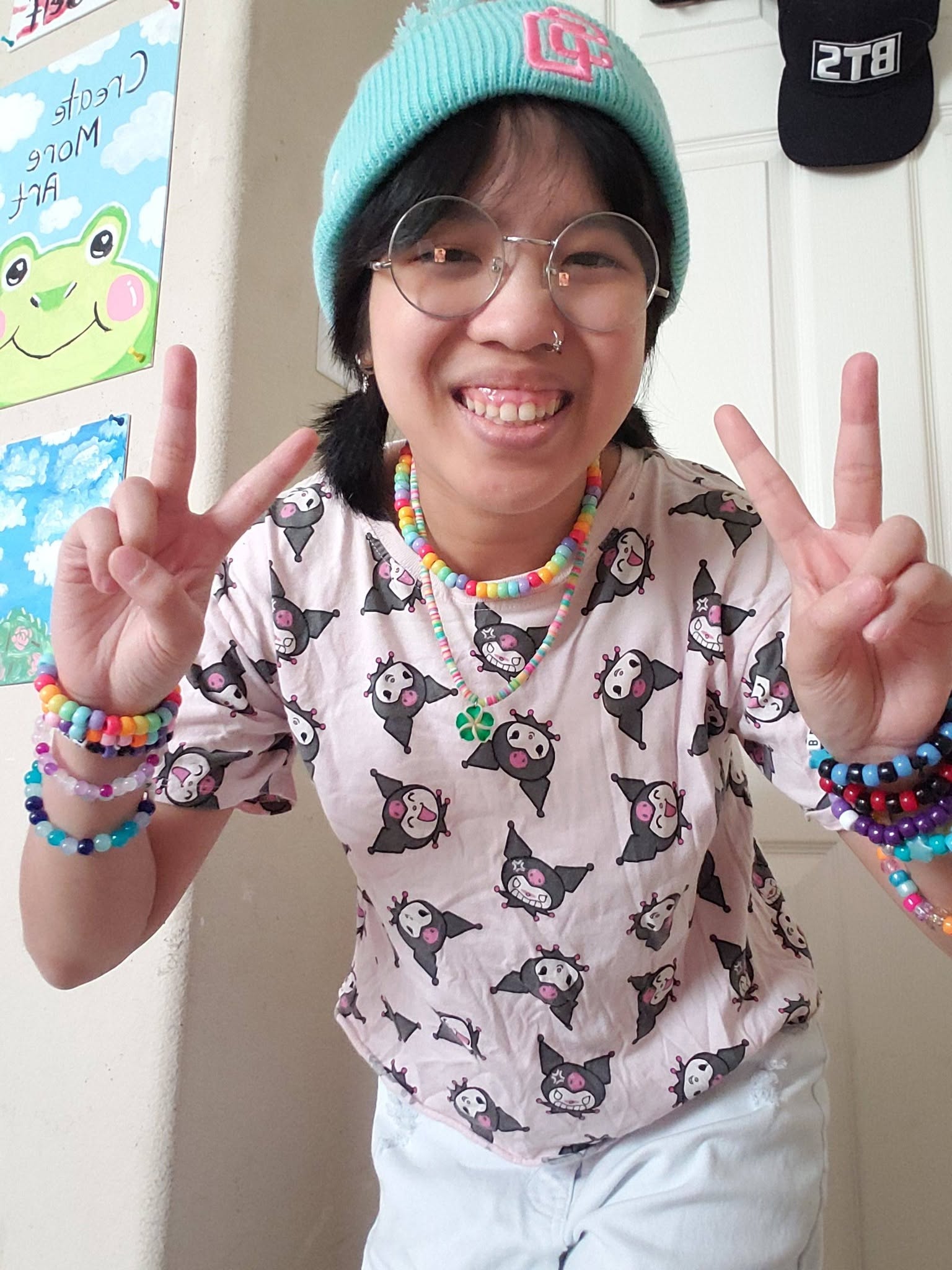 Portrait of Annabelle Jaime smiling and holding up peace signs